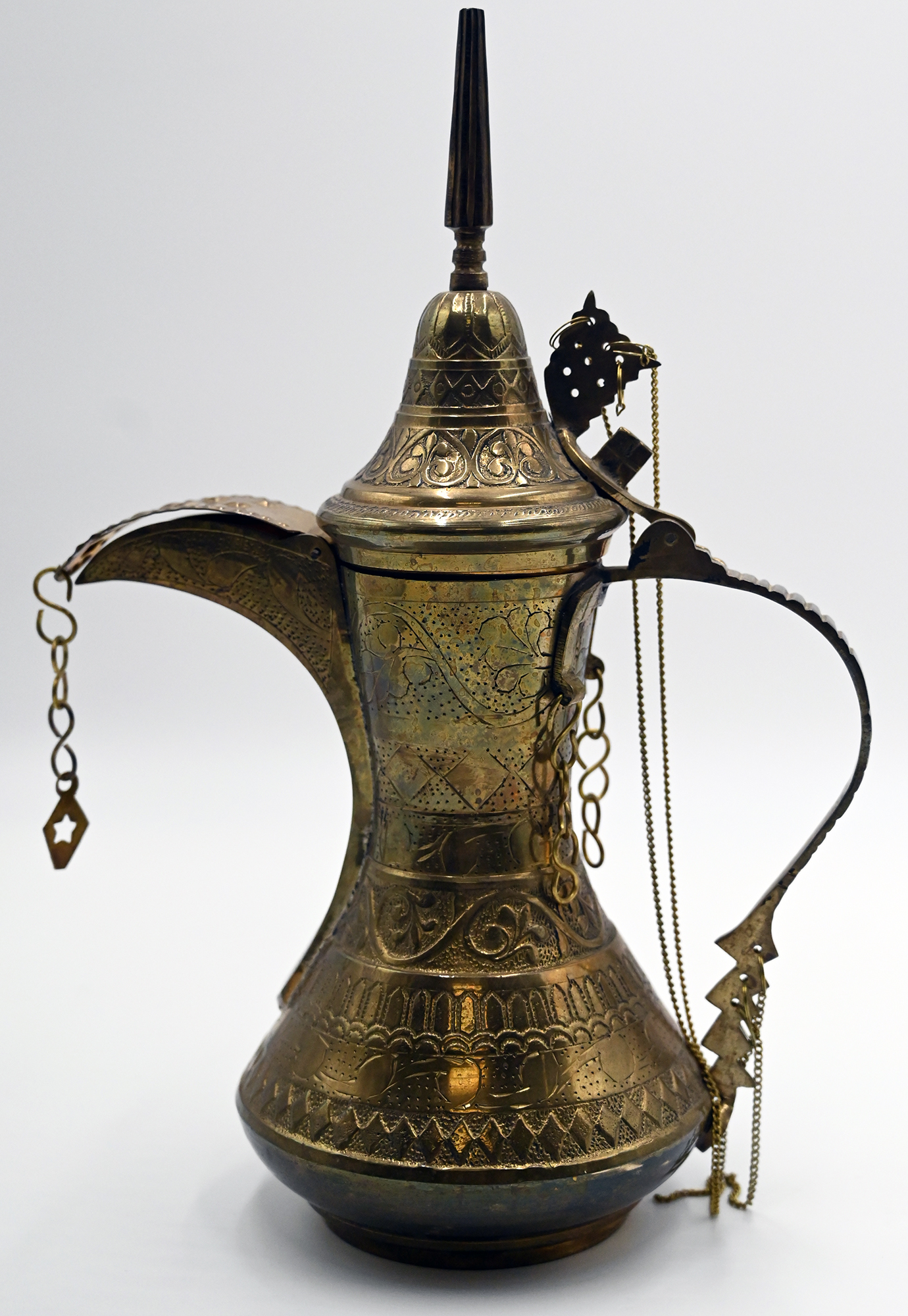 An Islamic brass teapot with six sided body